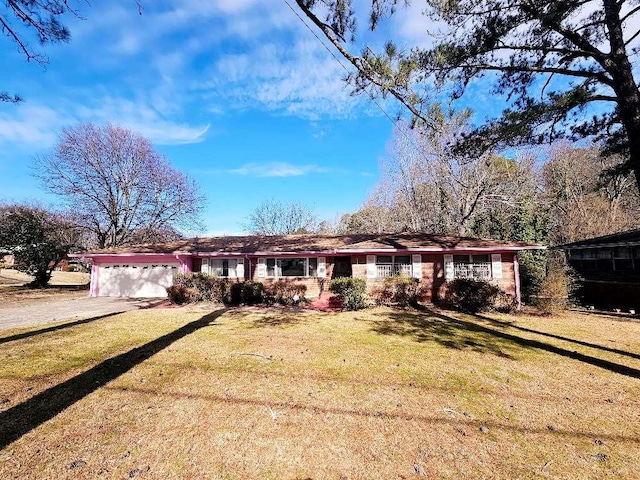 single story home featuring a garage and a front lawn