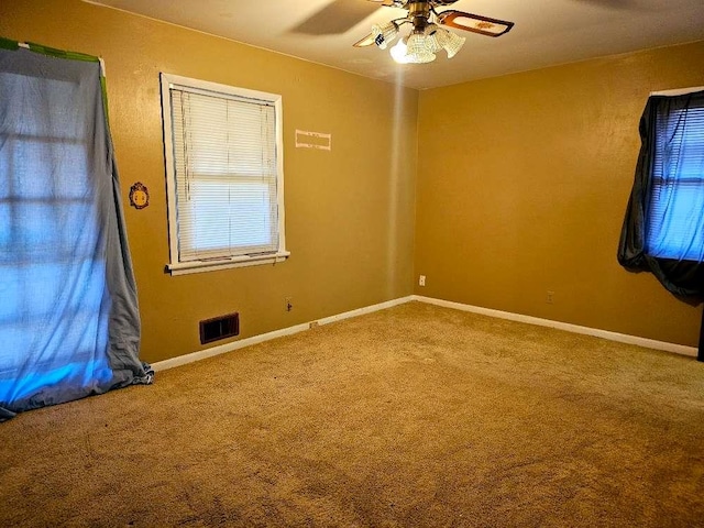 carpeted empty room with ceiling fan