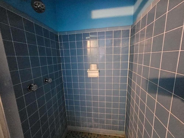 bathroom with tiled shower