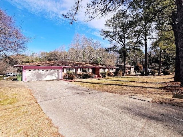 view of front of home with a garage and a front lawn