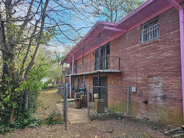 rear view of property featuring a balcony