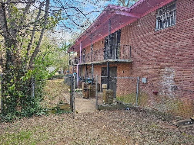 view of side of home with a balcony