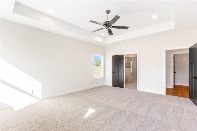102 Red Oak Ln, Carrollton, GA 30116 - unfurnished bedroom featuring a tray ceiling, carpet, recessed lighting, connected bathroom, and ceiling fan