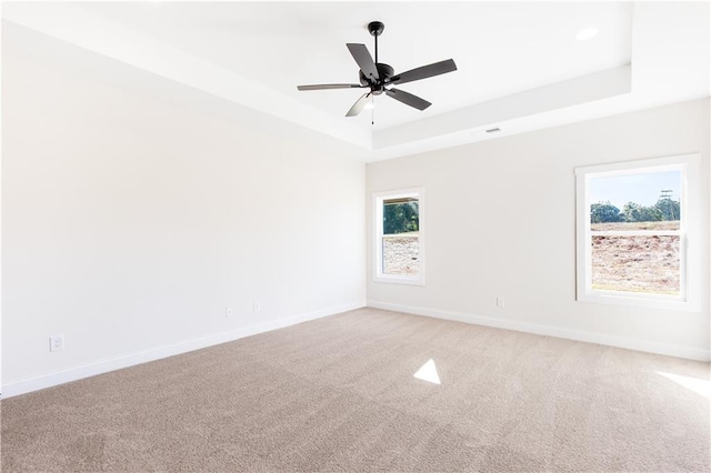 102 Red Oak Ln, Carrollton, GA 30116 - unfurnished room with a tray ceiling, light colored carpet, and a ceiling fan