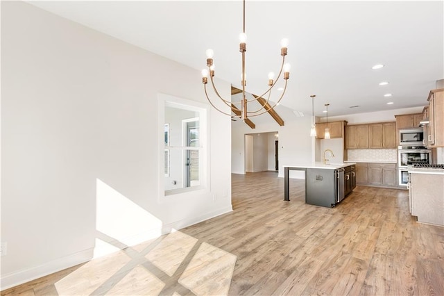 102 Red Oak Ln, Carrollton, GA 30116 - kitchen featuring stainless steel appliances, a chandelier, light countertops, pendant lighting, and a kitchen bar