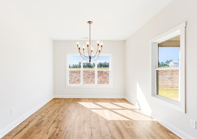102 Red Oak Ln, Carrollton, GA 30116 - unfurnished dining area with a chandelier and wood finished floors