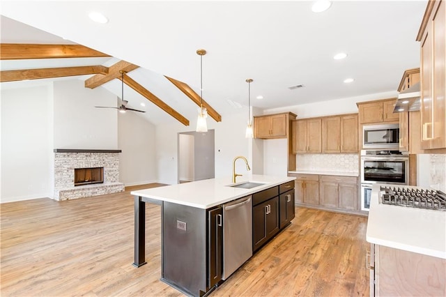 102 Red Oak Ln, Carrollton, GA 30116 - kitchen featuring stainless steel appliances, light countertops, light wood finished floors, backsplash, and recessed lighting