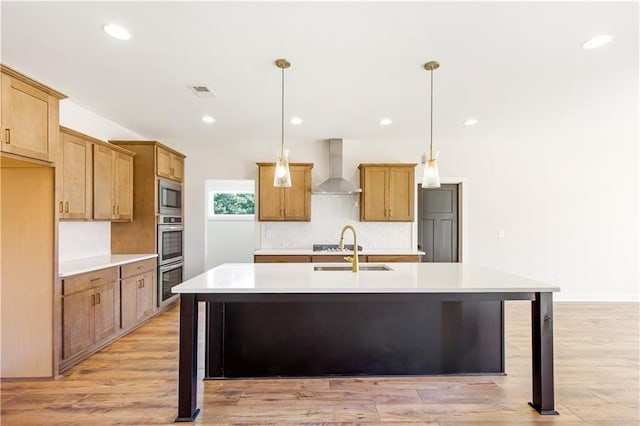 102 Red Oak Ln, Carrollton, GA 30116 - kitchen featuring wall chimney exhaust hood, appliances with stainless steel finishes, backsplash, light countertops, and a center island with sink