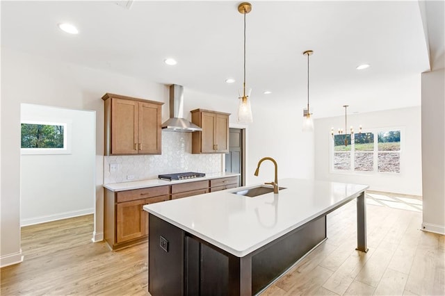 102 Red Oak Ln, Carrollton, GA 30116 - kitchen with wall chimney exhaust hood, stainless steel gas cooktop, healthy amount of natural light, light wood-type flooring, and recessed lighting