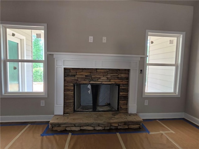 8970 Callaway Dr, Winston, GA 30187 - detailed view of a stone fireplace, baseboards, and wood finished floors
