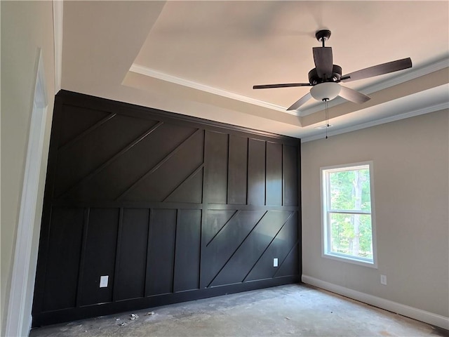 8970 Callaway Dr, Winston, GA 30187 - empty room featuring a raised ceiling, ornamental molding, a ceiling fan, unfinished concrete flooring, and baseboards