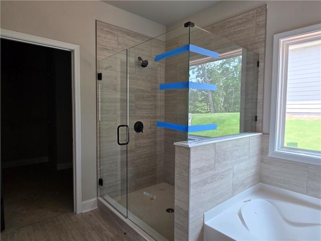8970 Callaway Dr, Winston, GA 30187 - full bath with a stall shower, a garden tub, and wood finished floors