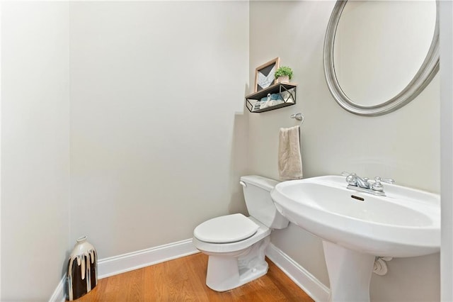 525 Roland Manor Dr, Dacula, GA 30019 - half bath featuring baseboards, wood finished floors, and toilet