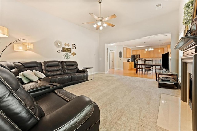 525 Roland Manor Dr, Dacula, GA 30019 - living area with light carpet, ceiling fan, baseboards, and a fireplace with flush hearth