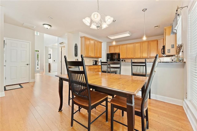 525 Roland Manor Dr, Dacula, GA 30019 - dining room featuring baseboards, a chandelier, and light wood-type flooring