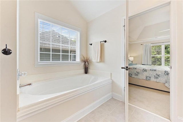 525 Roland Manor Dr, Dacula, GA 30019 - bathroom with lofted ceiling, ensuite bathroom, a garden tub, tile patterned floors, and baseboards