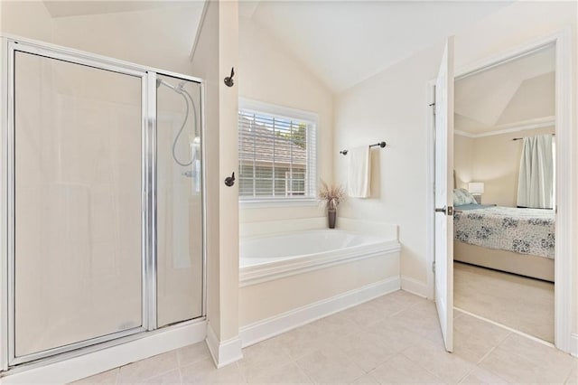 525 Roland Manor Dr, Dacula, GA 30019 - full bathroom with lofted ceiling, ensuite bath, a garden tub, a stall shower, and tile patterned flooring