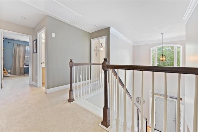 525 Roland Manor Dr, Dacula, GA 30019 - hall with attic access, an upstairs landing, carpet flooring, baseboards, and ornamental molding