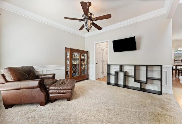 525 Roland Manor Dr, Dacula, GA 30019 - living area with ornamental molding, a ceiling fan, a wainscoted wall, and carpet floors