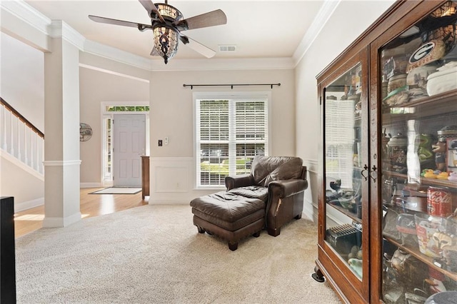 525 Roland Manor Dr, Dacula, GA 30019 - living area featuring carpet flooring, ceiling fan, decorative columns, crown molding, and wainscoting