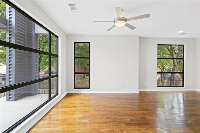 unfurnished room featuring ceiling fan and hardwood / wood-style flooring