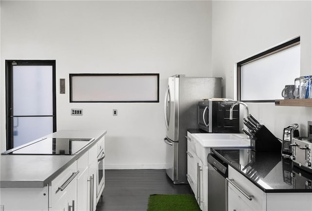 kitchen with sink, white cabinetry, and stainless steel appliances