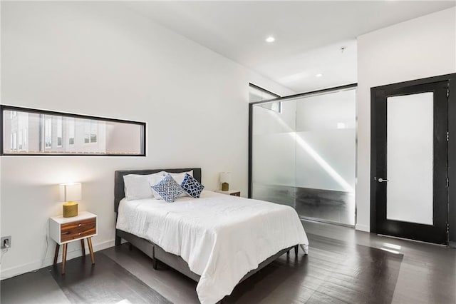 bedroom with dark wood-type flooring