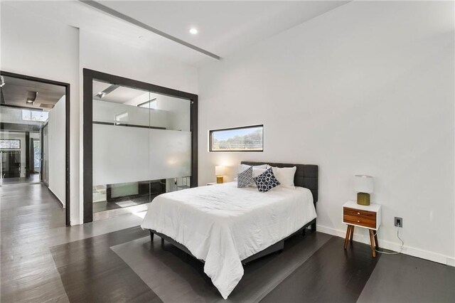 bedroom with dark hardwood / wood-style flooring