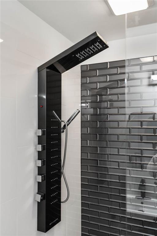 interior details featuring a tile shower