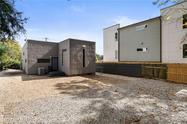 rear view of house with central AC unit