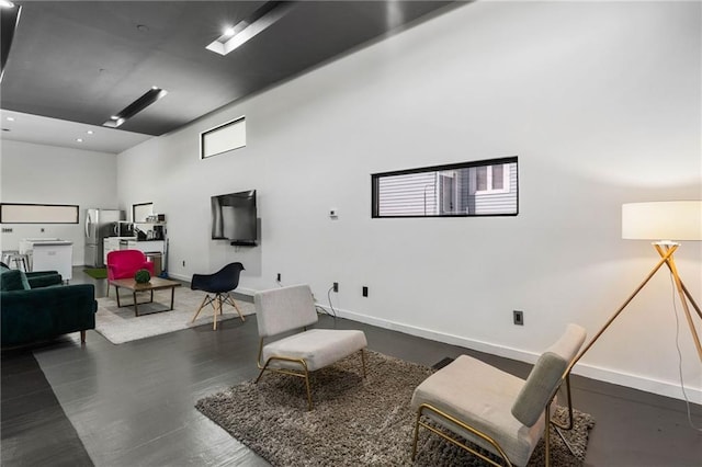 sitting room with a towering ceiling