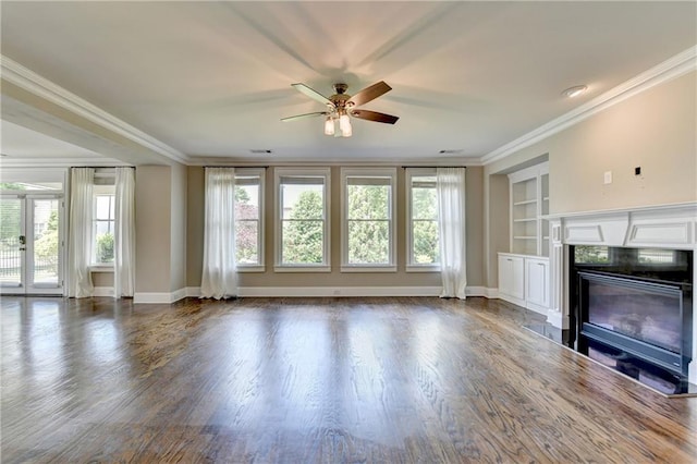 3910 Cameron Ct, Cumming, GA 30040 - unfurnished living room with ceiling fan, built in features, dark wood-style floors, a glass covered fireplace, and ornamental molding