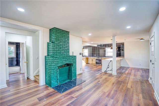 living room featuring dark hardwood / wood-style floors, a brick fireplace, and beverage cooler