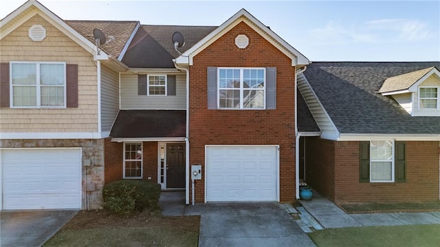 townhome / multi-family property featuring a garage