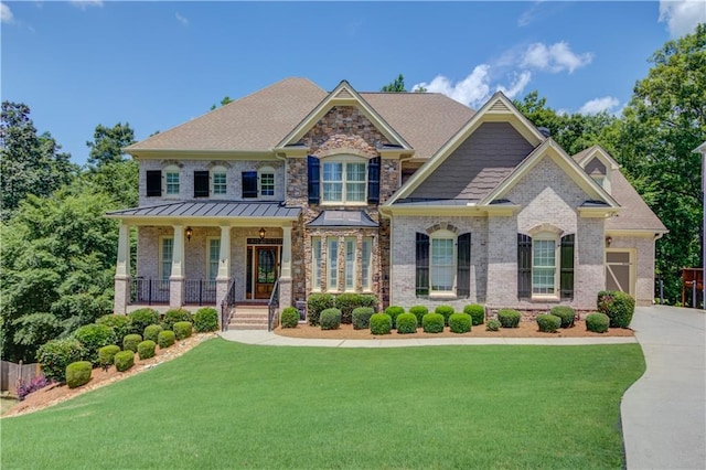 255 Beech Tree Holw, Sugar Hill, GA 30518 - craftsman house featuring covered porch, a front yard, driveway, and brick siding