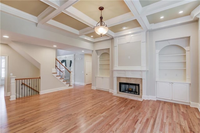 255 Beech Tree Holw, Sugar Hill, GA 30518 - unfurnished living room with light wood-type flooring, coffered ceiling, beamed ceiling, built in shelves, and a fireplace with flush hearth