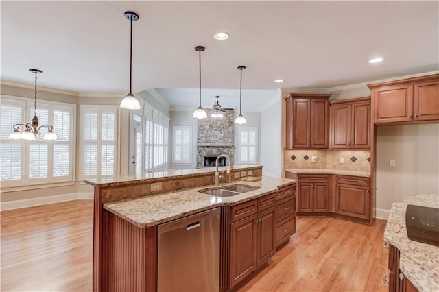 255 Beech Tree Holw, Sugar Hill, GA 30518 - kitchen with stainless steel dishwasher, a sink, light wood-style floors, brown cabinetry, and backsplash
