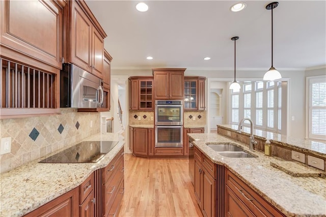 255 Beech Tree Holw, Sugar Hill, GA 30518 - kitchen with a sink, appliances with stainless steel finishes, brown cabinets, ornamental molding, and light wood-style floors