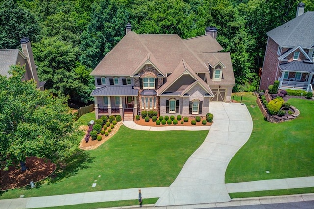 255 Beech Tree Holw, Sugar Hill, GA 30518 - craftsman-style home with concrete driveway, a front yard, an attached garage, stone siding, and covered porch
