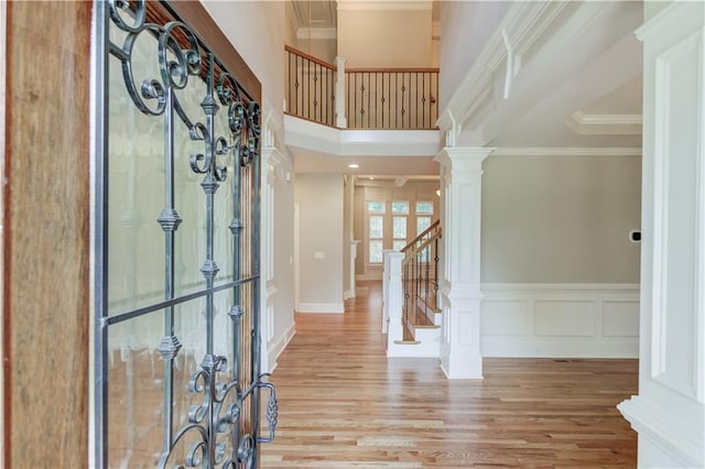 255 Beech Tree Holw, Sugar Hill, GA 30518 - entryway with wood finished floors, stairway, crown molding, decorative columns, and a towering ceiling