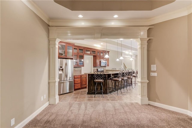 255 Beech Tree Holw, Sugar Hill, GA 30518 - kitchen with appliances with stainless steel finishes, a breakfast bar, ornate columns, light carpet, and crown molding