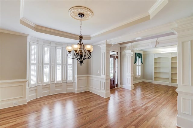 255 Beech Tree Holw, Sugar Hill, GA 30518 - unfurnished room featuring crown molding, a chandelier, light wood-style flooring, a decorative wall, and decorative columns