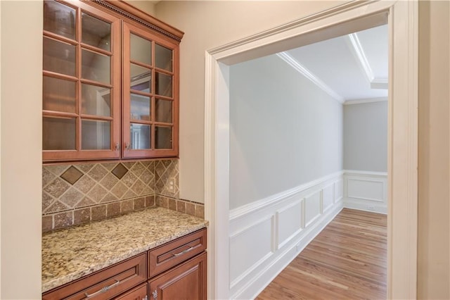 255 Beech Tree Holw, Sugar Hill, GA 30518 - bar featuring decorative backsplash, ornamental molding, light wood-type flooring, a decorative wall, and wainscoting