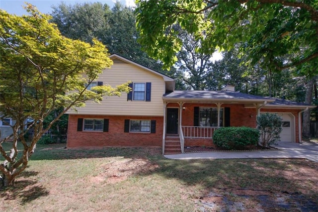 split level home featuring a porch, a garage, and a front lawn