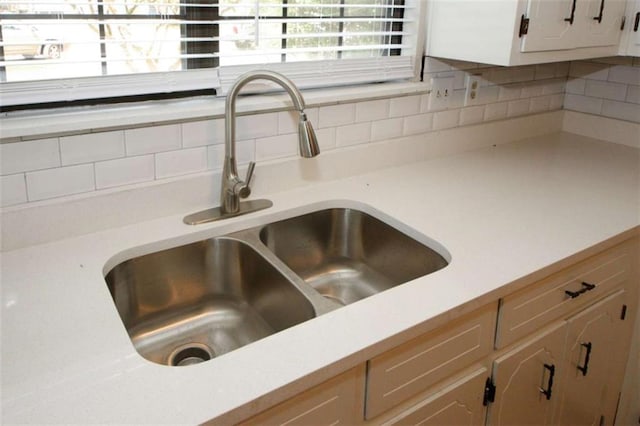 interior details with white cabinetry and sink