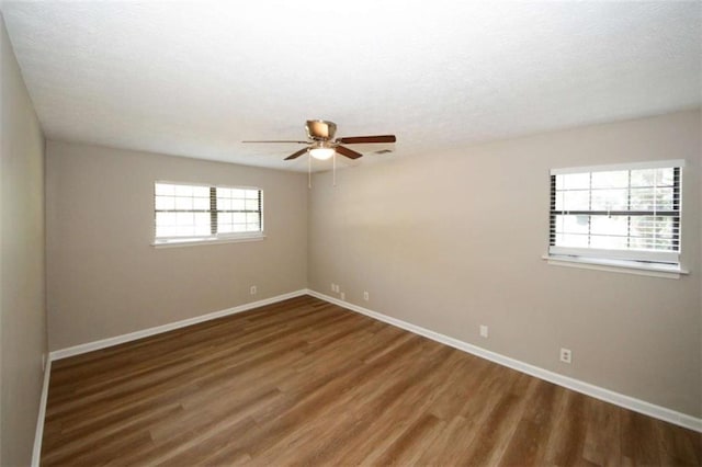 empty room featuring ceiling fan and dark hardwood / wood-style flooring