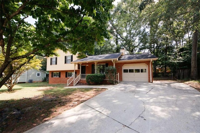 split level home featuring a porch and a garage