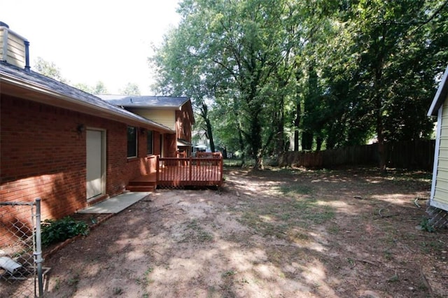 view of yard with a wooden deck