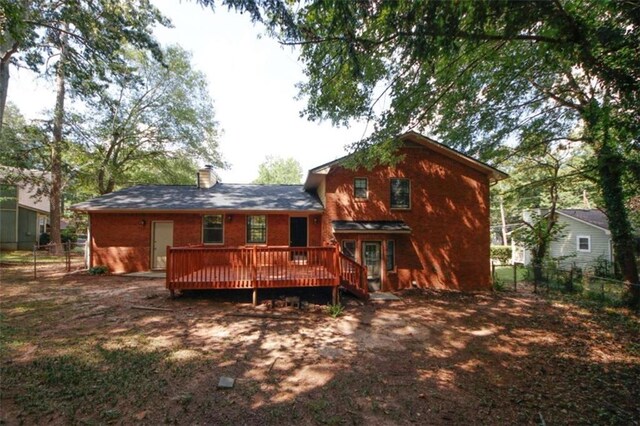 back of house with a wooden deck