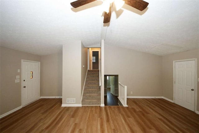 empty room featuring hardwood / wood-style floors and vaulted ceiling